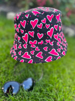Load image into Gallery viewer, lusciousscarves Black Reversible Bucket Hat with Pink Hearts Design
