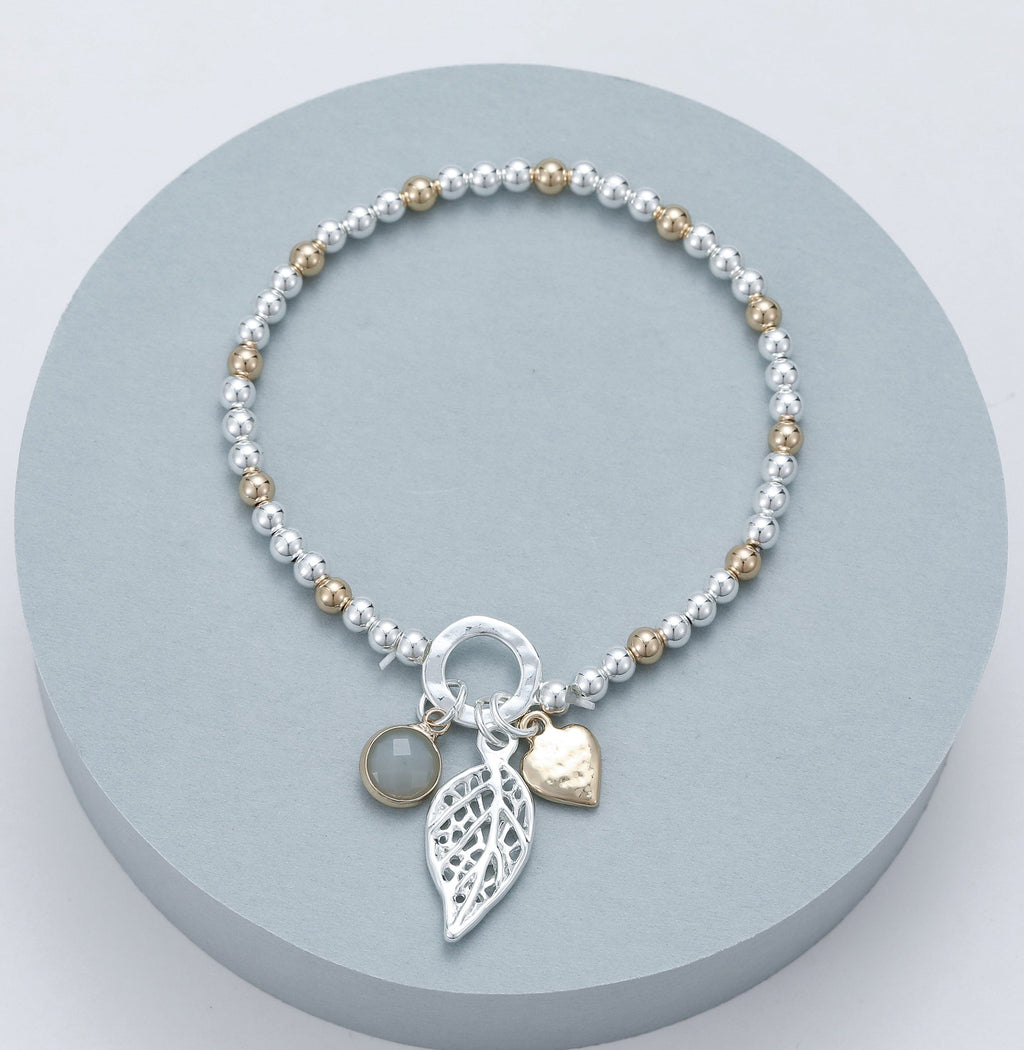 lusciousscarves Gracee Stretchy Silver and Rose Gold Bracelet with a Heart, Leaf and Grey Faceted Glass Charms.