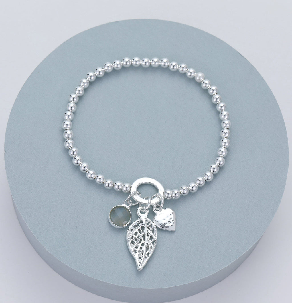 lusciousscarves Gracee Stretchy Silver Bracelet with a Heart, Leaf and Grey Faceted Glass Charms.